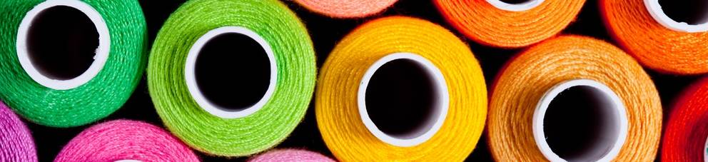 Sewing threads as a multicolored background close up